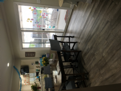 View from the living room to the dining room table. Looks out to the window doors to view the beautiful backyard. 